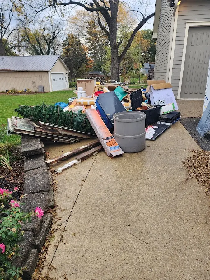 Dumpster being loaded with debris for Commercial Dumpster Rental in Romulus